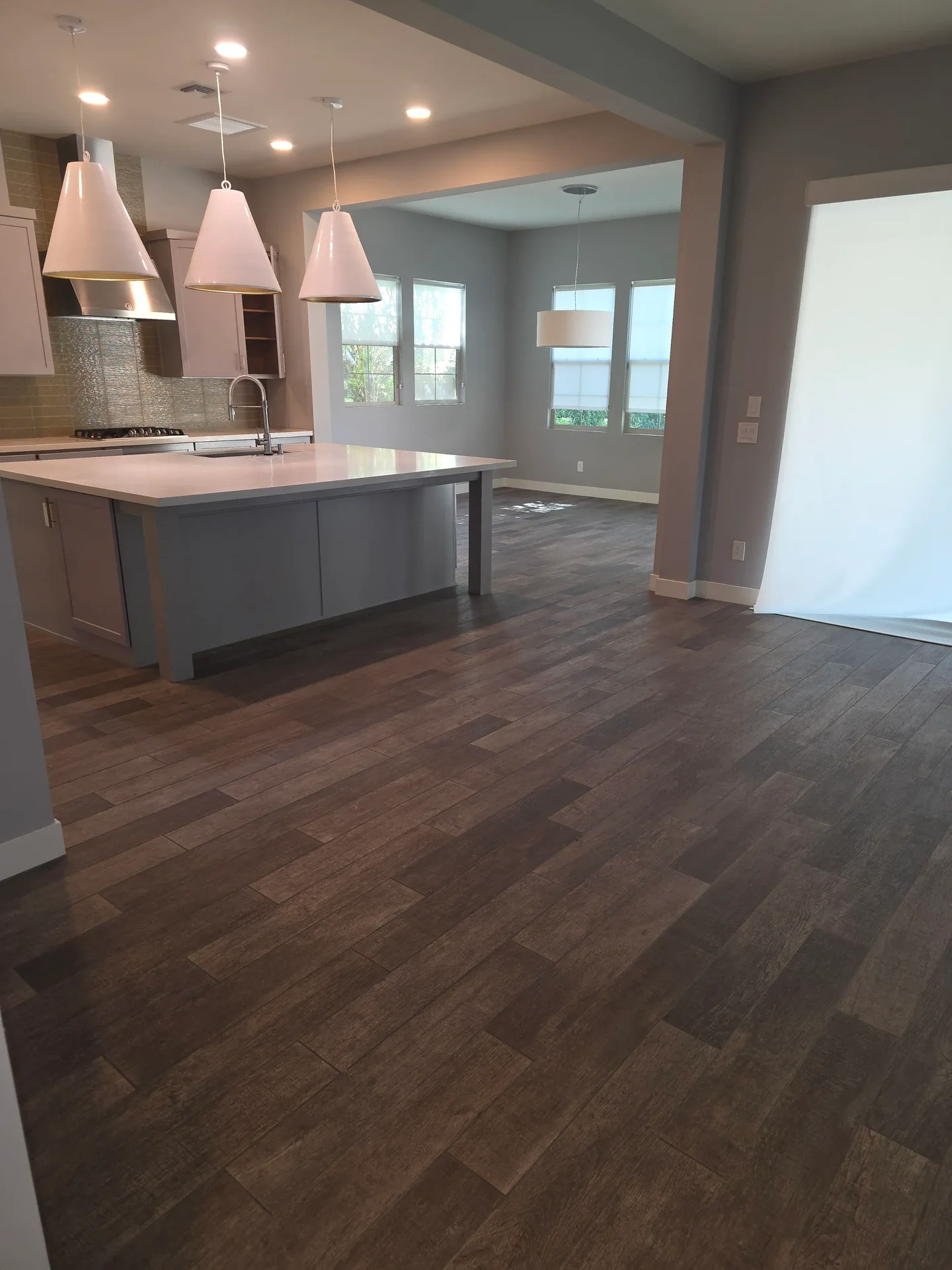 Empty kitchen and living area after a Greater Phoenix Cleaning move-out clean