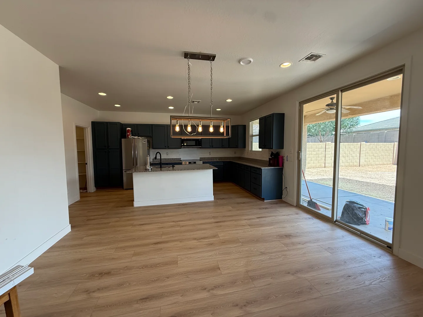 Empty kitchen and living area after a Greater Phoenix Cleaning move-out clean
