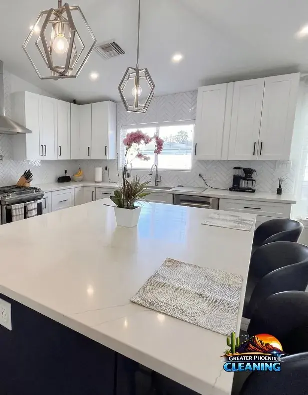Modern white quartz island kitchen, polished and reset after a deep clean